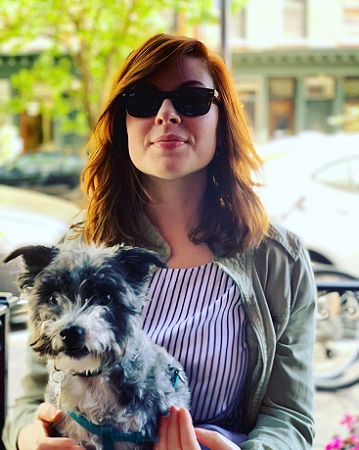 Kate Rogers posing with her dog